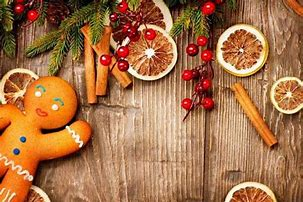 Gingerbread cookie and holiday decorations of cinnomin, berries and orange peels