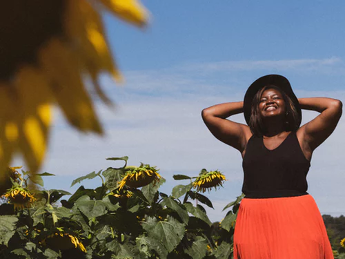 Woman among sunflowers